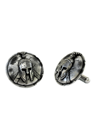 Authentic Spartan Helmet 925 sterling silver cufflinks - angled pair view on a cracked shield backdrop, showcasing the warrior aesthetic.
