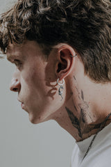 Back view of the Dragon Wing Earring's huggie hoop, displaying the "925" hallmark and secure hinged closure.