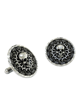 Black Sun Skull Cuffs shown on a shirt cuff to demonstrate their actual size and powerful, mystical appearance when worn.