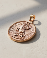Rose gold plated Saint George pendant featuring knight slaying dragon with braided border design
