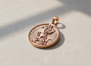 Rose gold plated Saint George pendant featuring knight slaying dragon with braided border design