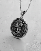 Oxidized silver Saint George pendant shown on a matching chain, demonstrating its wearability as a religious necklace.