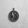 Silver Saint George pendant with detailed high relief of the knight and dragon on a textured light grey surface.