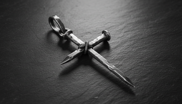 Close-up detail of Nail Cross Pendant sterling silver pendant highlighting rope binding and hammered nail texture