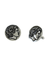 Close-up detail of a single Alexander the Great sterling silver cufflink, focusing on the divine ram's horn and the coin-like finish.