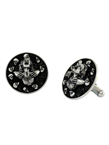 Close-up detail of a single Death's Embrace sterling silver cufflink, focusing on the tormented expression and the surrounding halo of skulls.