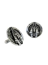 Close-up detail of a single God Anubis sterling silver cufflink, focusing on the fierce jackal expression and the Nemes headdress.