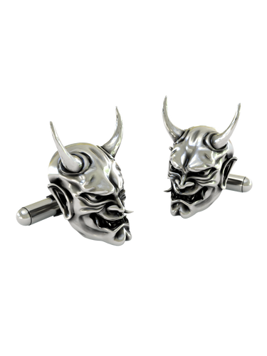Close-up detail of a single Japanese Oni demon sterling silver cufflink, focusing on the sharp horns and expressive facial details.