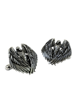 Close-up detail of a single Majestic Eagle sterling silver cufflink, focusing on the sharp gaze and the texture of the individual feathers.