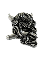 Close-up detail of a single Samurai Mempo sterling silver cufflink, focusing on the sharp fangs, menacing expression, and textured finish.