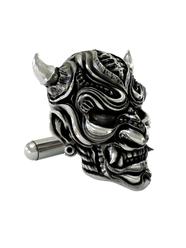 Close-up detail of a single Samurai Mempo sterling silver cufflink, focusing on the sharp fangs, menacing expression, and textured finish.