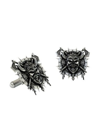 Close-up detail of a single Viking Berserker sterling silver cufflink, focusing on the menacing skull face, horned helmet, and braided beard.