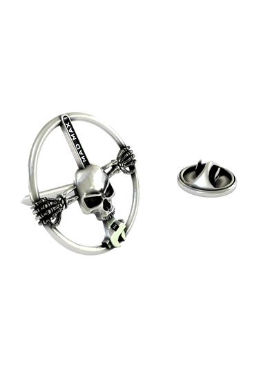 Close-up detail of the "MAD MAX" engraving and the grim skull face on the Mad Max Lapel Pin.