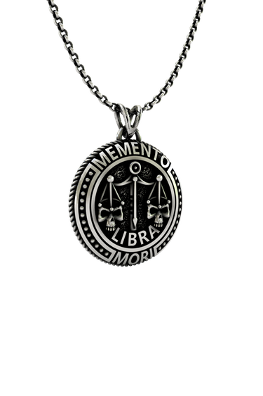 Close-up detail of the "Memento Mori" Latin inscription and the intricate skull on the Libra Zodiac Pendant.