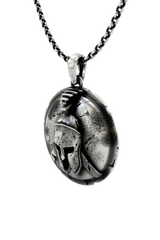 Close-up detail of the battle damage and texture on the Spartan Helmet Pendant, showing the fine craftsmanship.