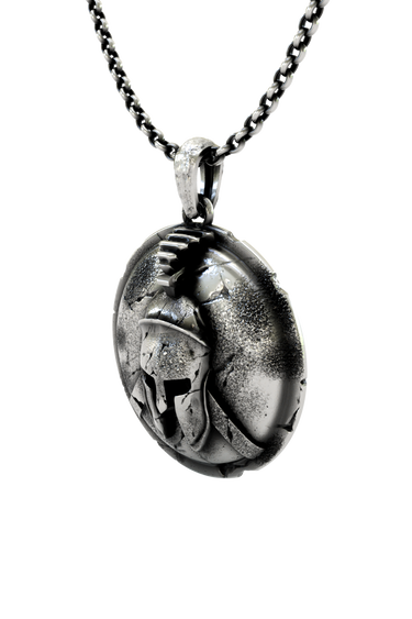Close-up detail of the battle damage and texture on the Spartan Helmet Pendant, showing the fine craftsmanship.
