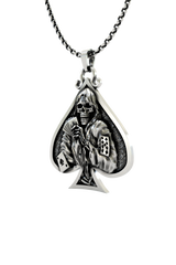 Close-up detail of the grimacing skull and playing cards on the Death Gambler Pendant.