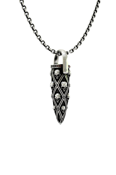 Close-up detail of the individual carved skulls and the row of red gems on the Skull Bullet Pendant.