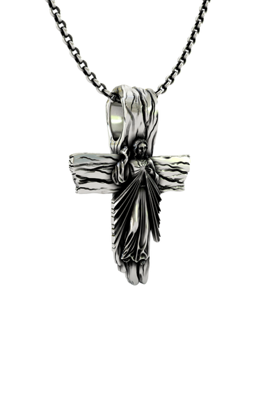 Close-up detail of the radiating robes and blessing gesture of Christ on the Sacred Cross Pendant.
