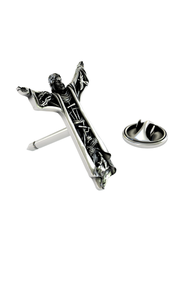 Close-up detail of the sculpted scenes and the face of Christ on the Silver Christ the Redeemer Pin.
