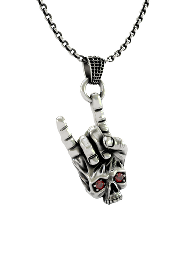Close-up detail of the skull face and fiery red stone eyes on the Rock Skull Pendant, emphasizing the craftsmanship.