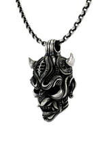 Close-up detail of the snarling fangs and intricate forehead design on the Oni Mask Pendant.