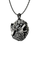 Close-up detail of the snarling wolf face on the Geralt of Rivia Wolf Medallion, emphasizing its aggressive aesthetic.