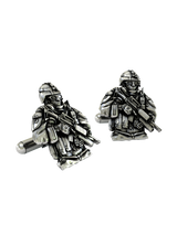 Close-up detail of the sterling silver Soldier Cufflinks, emphasizing the fine features of the helmet, glasses, and weapon.
