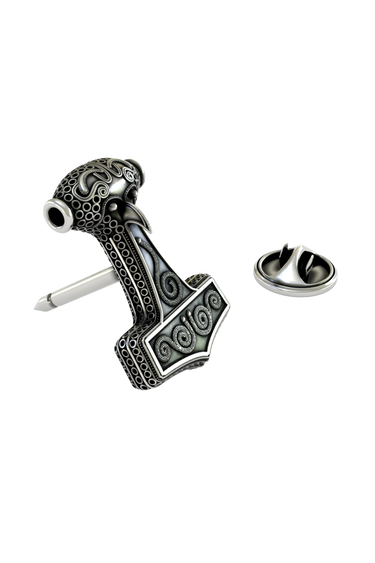 Close-up detail of the swirling patterns and stylized bird head on the Mjolnir Lapel Pin.