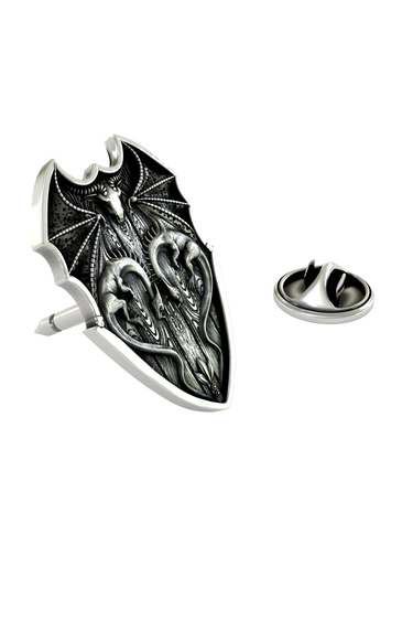 Close-up detail of the symmetrical dragons and dragon skull on the Silver Dragon Shield Lapel Pin.

