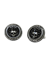 Close-up detail on the Memento Mori Virgo cufflinks, highlighting the intricate engraving on the skull and surrounding text.