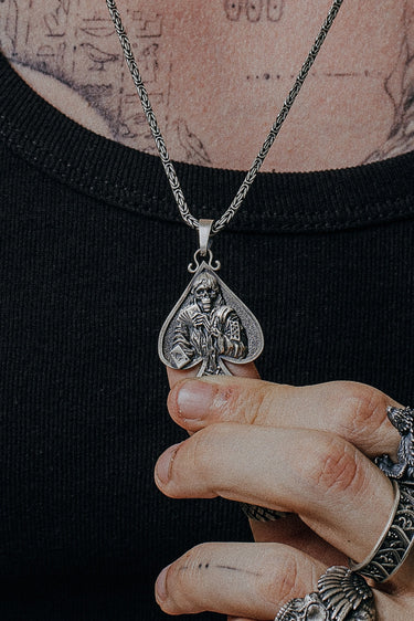 Death Gambler Pendant shown on a model to demonstrate its size and powerful presence as a statement necklace.