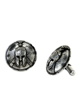 Dynamic shot of the Cracked Shield Spartan 925 silver cufflinks pair, emphasizing the heavy oxidation and historical artifact finish.