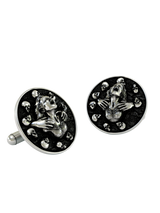 Dynamic shot of the Death's Embrace 925 silver cufflinks pair, emphasizing the dramatic expression and polished skull details.