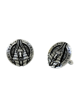 Dynamic shot of the Egyptian Anubis 925 silver cufflinks pair, emphasizing the detailed hieroglyphs and textured background.