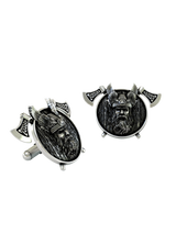 Dynamic shot of the Viking Warrior 925 silver cufflinks pair, emphasizing the textured wood-grain shield and Celtic knotwork on the axes.