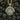 Sacred Flame Medallion Pendant, two-tone silver and gold, front view on charcoal