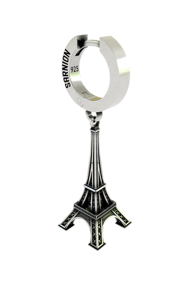 Macro close-up shot of the Parisian Tower Earring, focusing on the intricate lattice work of the famous French tower.