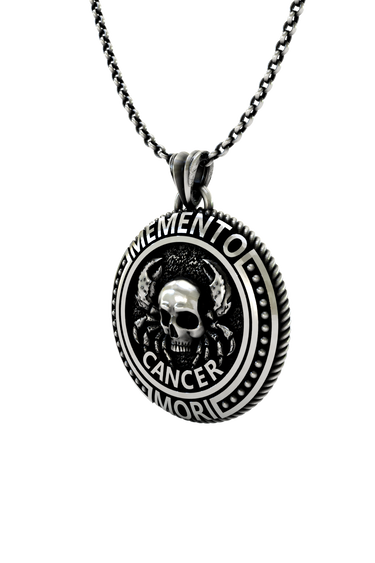 Memento Mori Cancer Pendant shown on a model to demonstrate its size and wearability as a statement necklace.