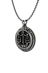 Memento Mori Libra Pendant shown on a model to demonstrate its size and wearability as a statement necklace.
