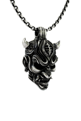 Oni Mask Pendant shown on a model to demonstrate its size and powerful presence as a statement necklace.