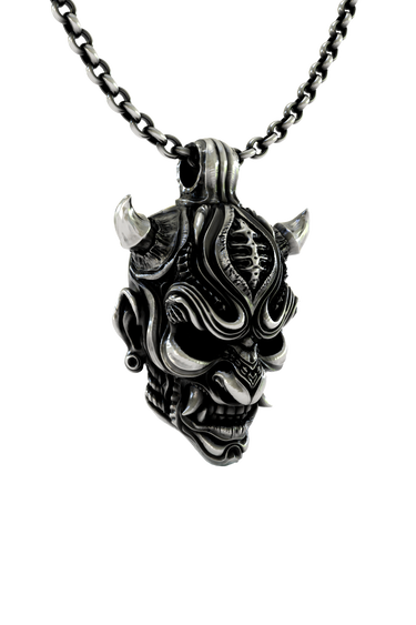 Oni Mask Pendant shown on a model to demonstrate its size and powerful presence as a statement necklace.