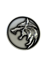 Side angle of the Wolf School Medallion Cuffs in sterling silver, showing the polished relief against the dark background.