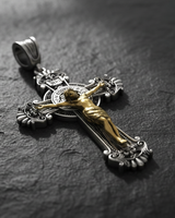 Side angle view of Saint Benedict Crucifix Pendant showing dimensional depth of gold corpus on oxidized silver ornate cross