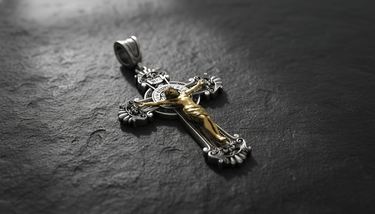 Side angle view of Saint Benedict Crucifix Pendant showing dimensional depth of gold corpus on oxidized silver ornate cross