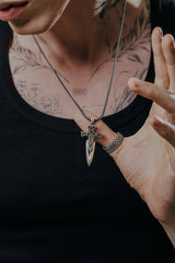 Side angle view of the Sterling Silver Celtic Dagger Pendant, showing the contrast between the oxidized knots and polished silver.