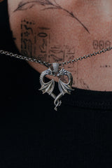 Side angle view of the Sterling Silver Dragon Love Pendant, highlighting the detailed scales and wings of the dragons.