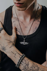 Side angle view of the Sterling Silver Isis Wings Pendant, highlighting the detailed texture of the wings and goddess figure.