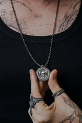 Side angle view of the Sterling Silver Memento Mori Cancer Pendant, highlighting the 3D relief of the skull and crab claws.