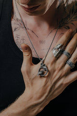 Side angle view of the Sterling Silver Odin Ravens Pendant, highlighting the intricate feather details of the birds.